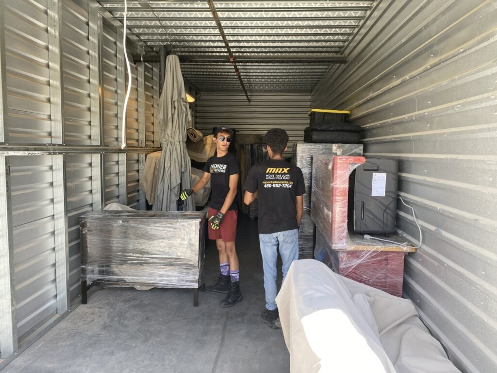 Premier Junk Movers crew loading a storage container