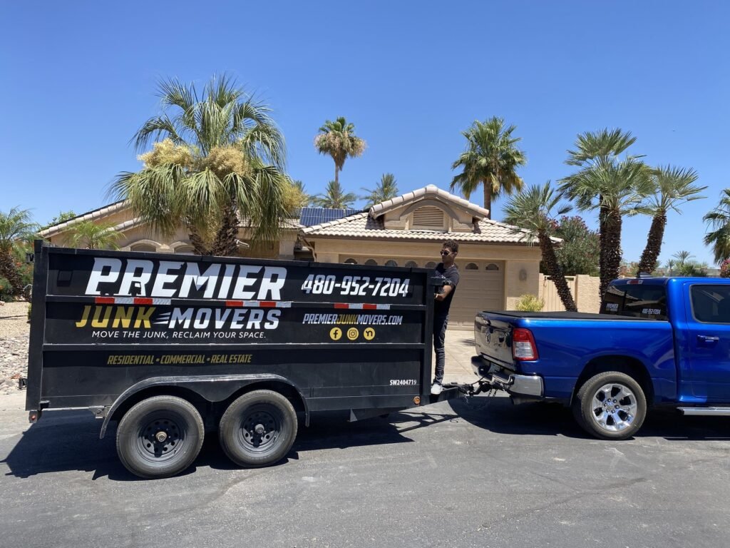 Premier Junk Movers blue truck with branded trailer