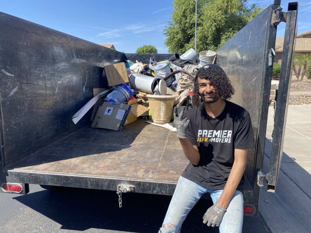 Premier Junk Movers team member on a loaded trailer
