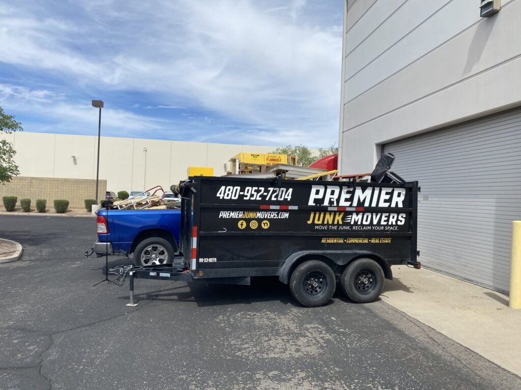 Premier Junk Movers loaded trailer at a job site