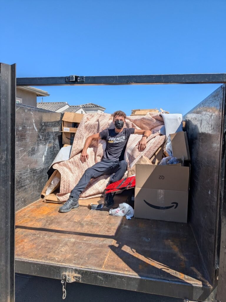 Premier Junk Movers team member inside a loaded trailer